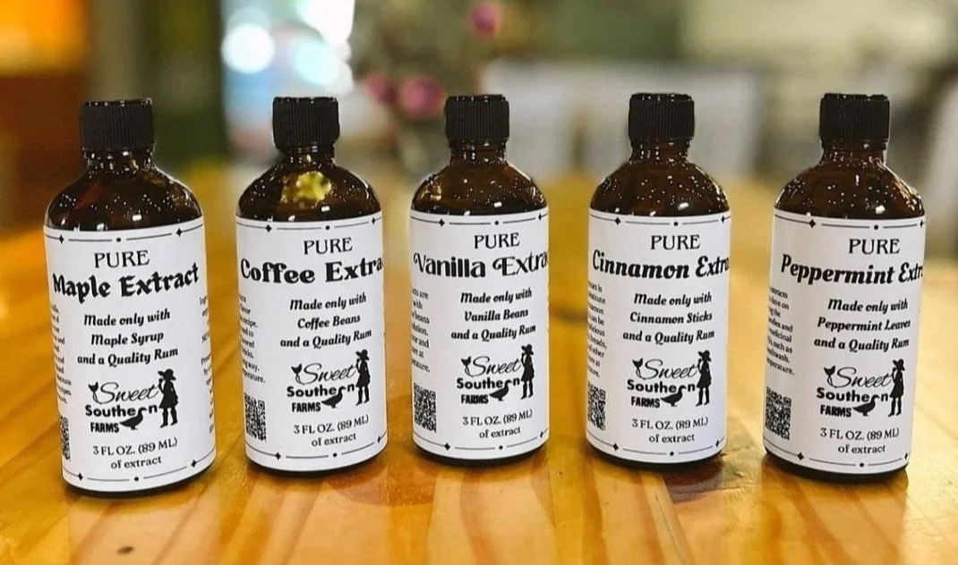 A row of pure extract bottles: maple, coffee, vanilla, cinnamon and peppermint