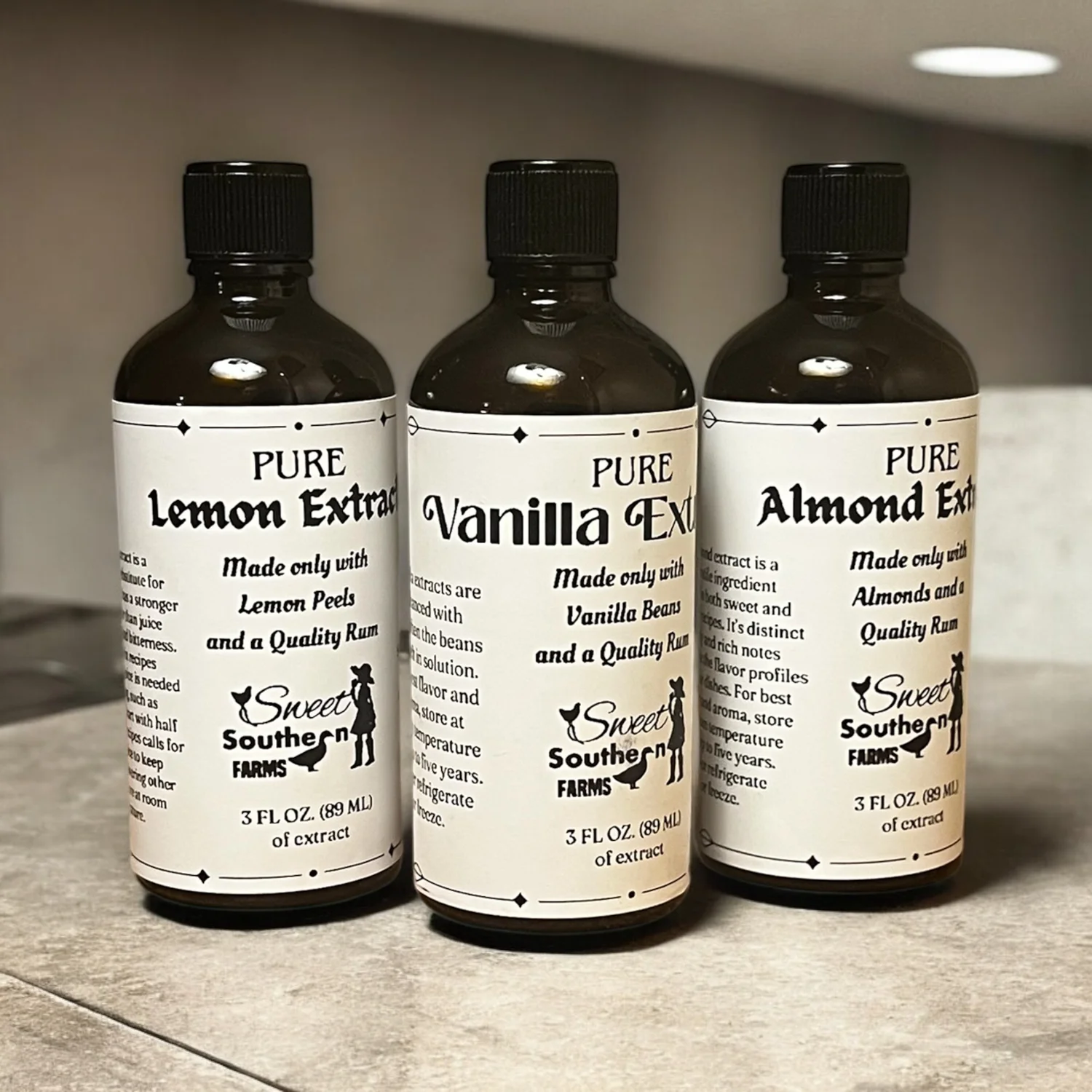 Lemon, vanilla and almond pure extracts on a kitchen counter
